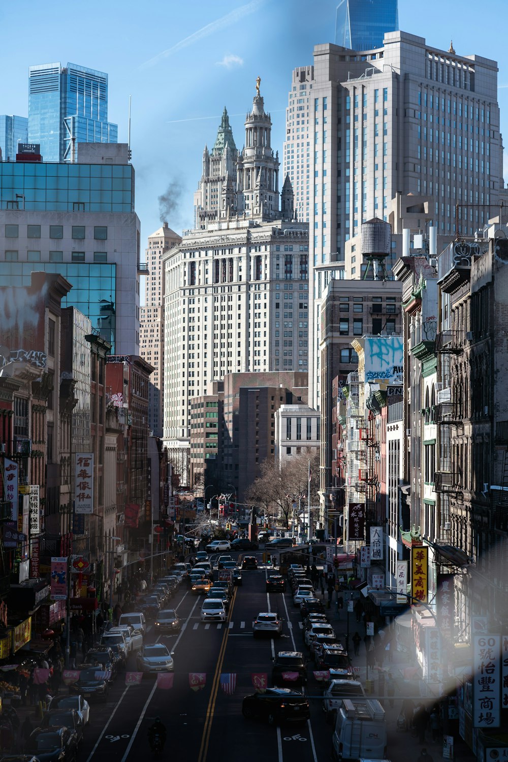 a busy city street with tall buildings in the background