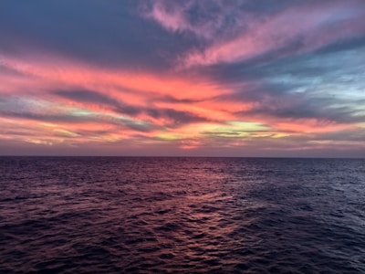 A stunning sunset blending pink and orange hues over the Mediterranean Sea.