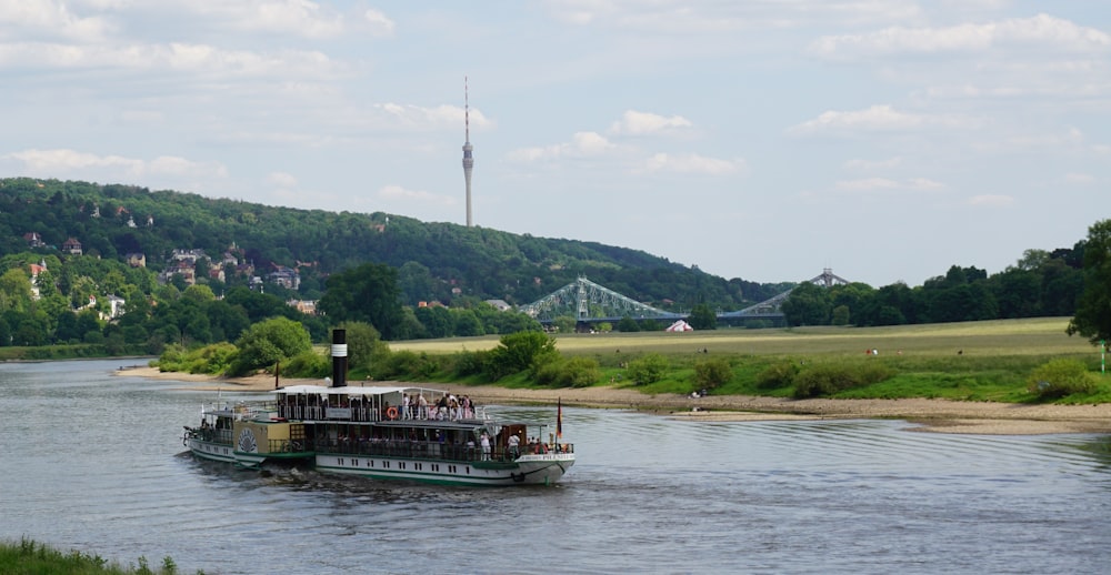 a large boat is traveling down a river