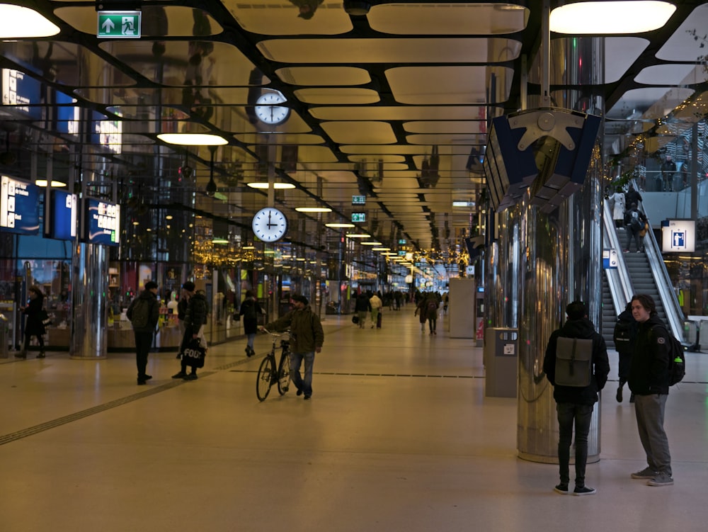 a group of people standing around a train station