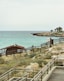 a wooden walkway leading to a beach next to the ocean