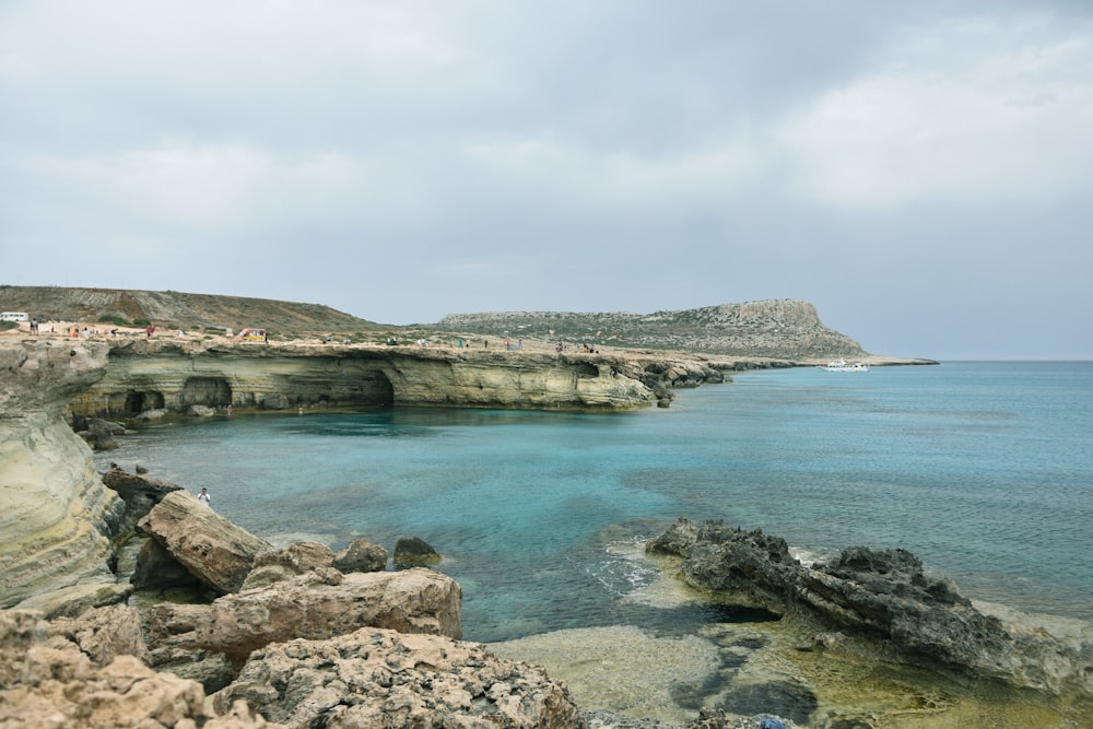 a body of water near a rocky shore