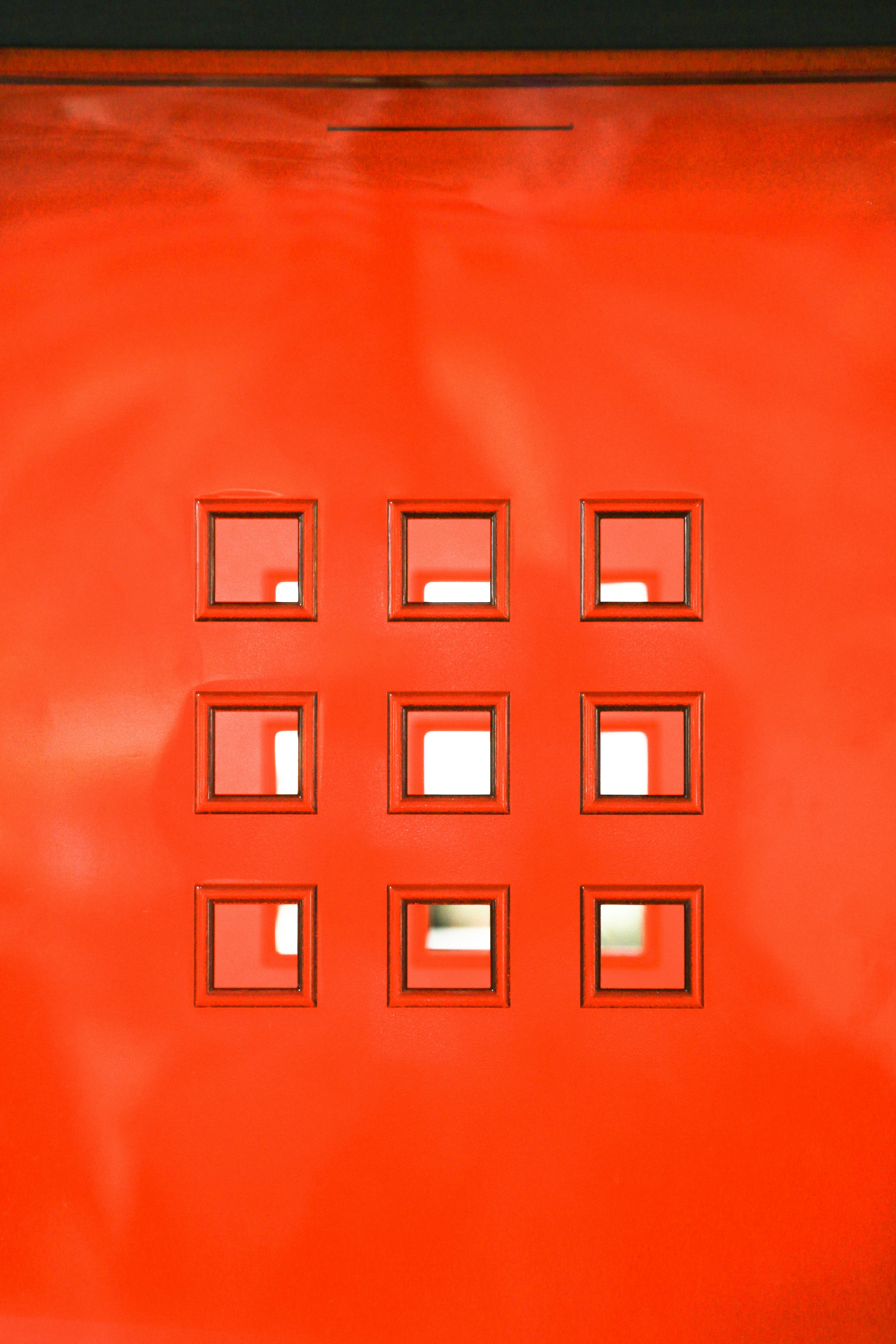 a close up of a red door with nine windows