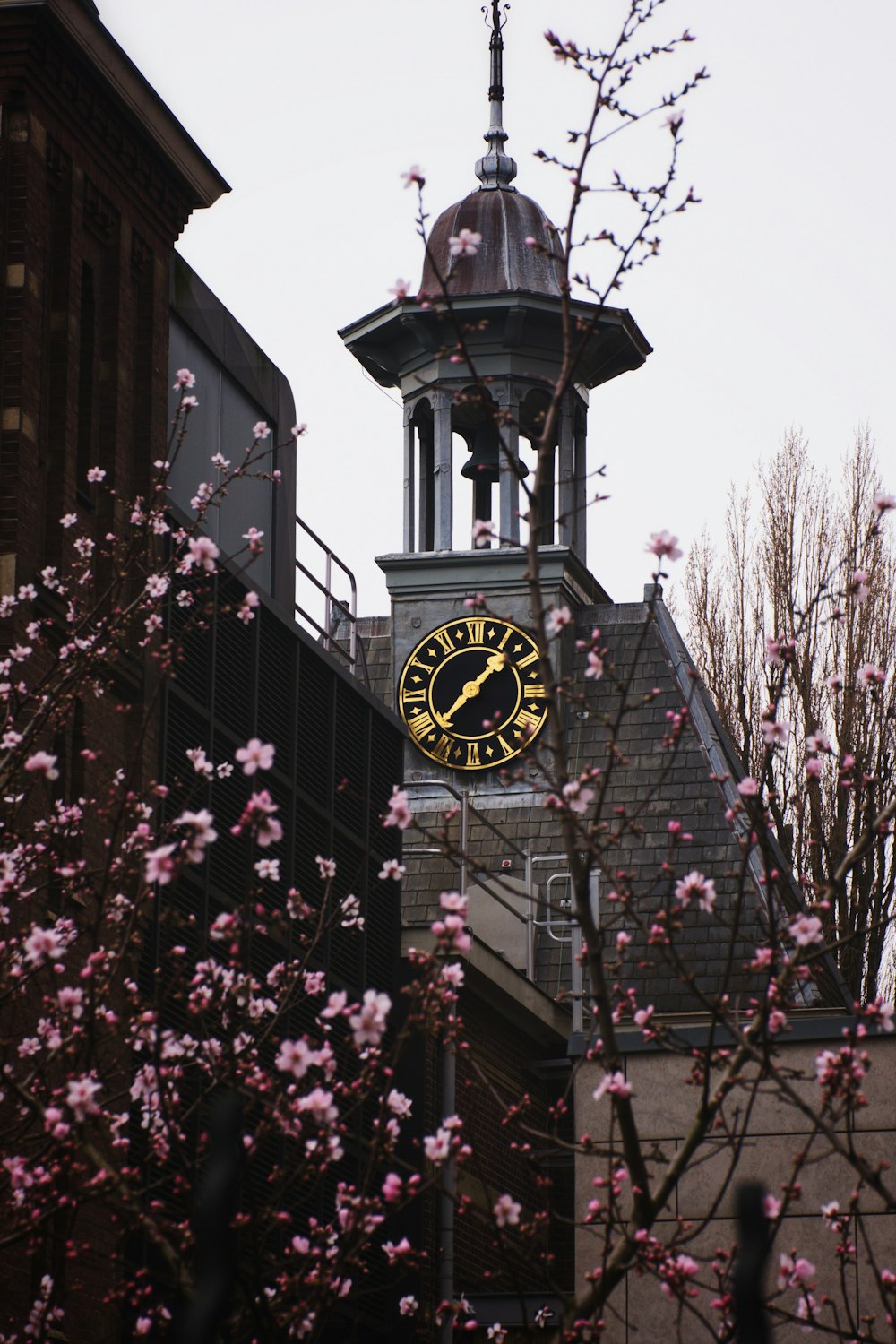 a clock tower with a yellow and black clock on it