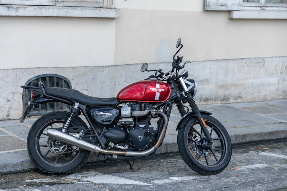 a red motorcycle parked on the side of the road