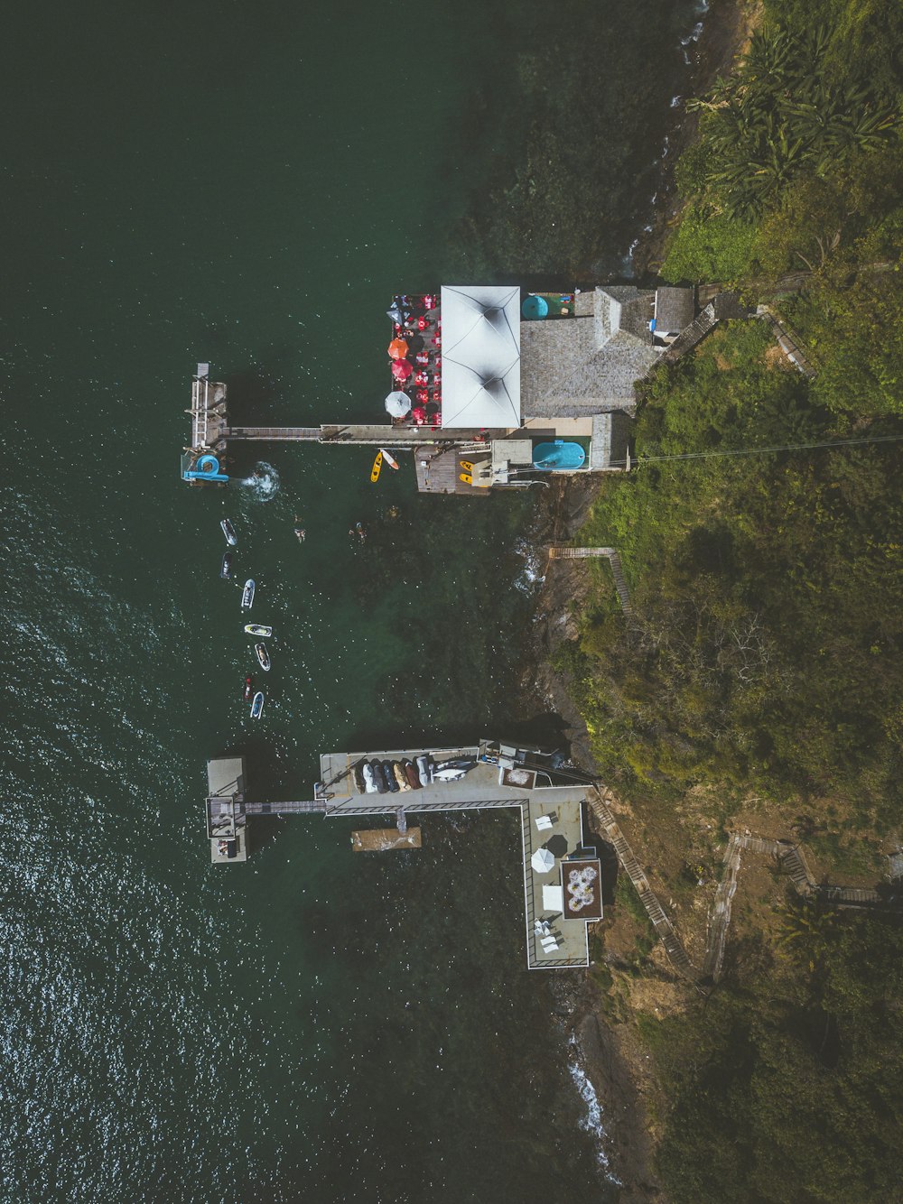 an aerial view of a dock with boats