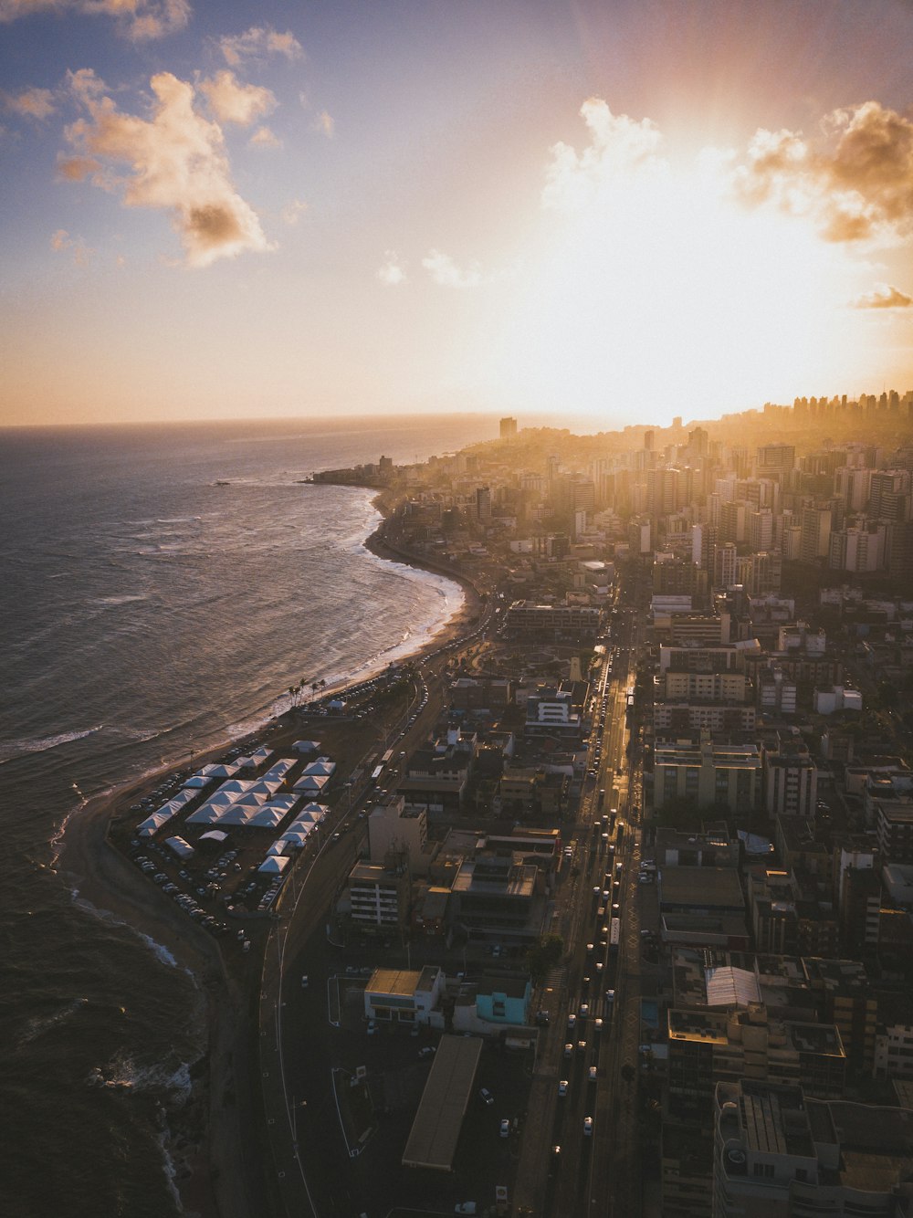 an aerial view of a city next to the ocean