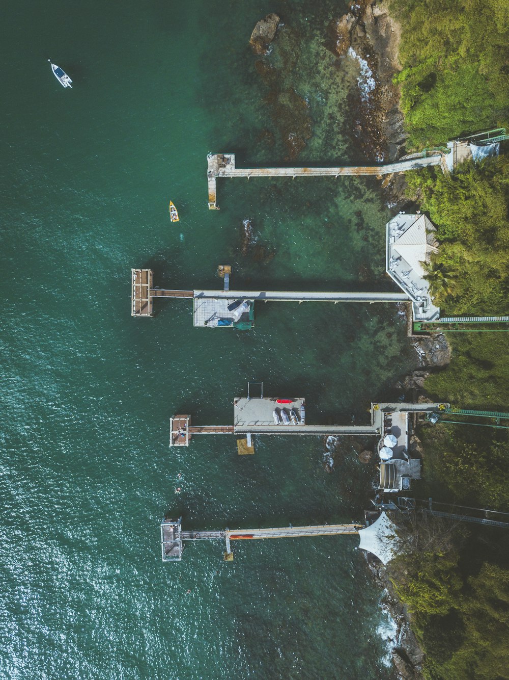 an aerial view of a pier on the water