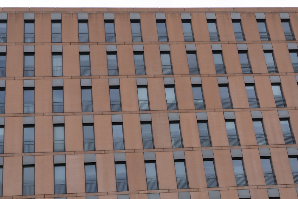 a tall building with lots of windows next to a parking meter