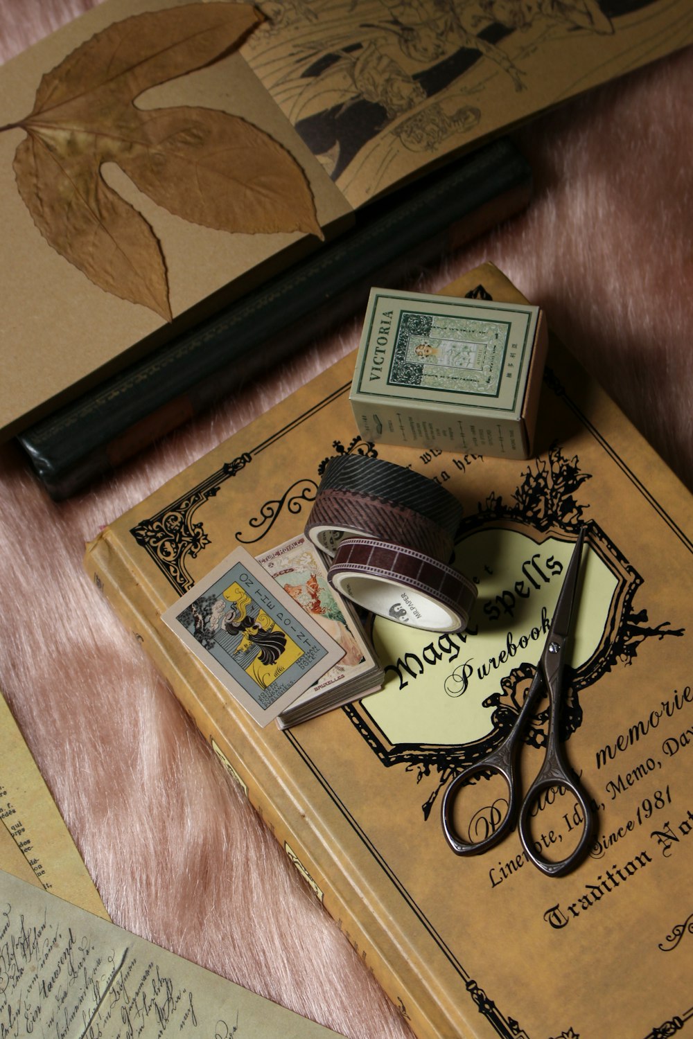 a pair of scissors sitting on top of a book