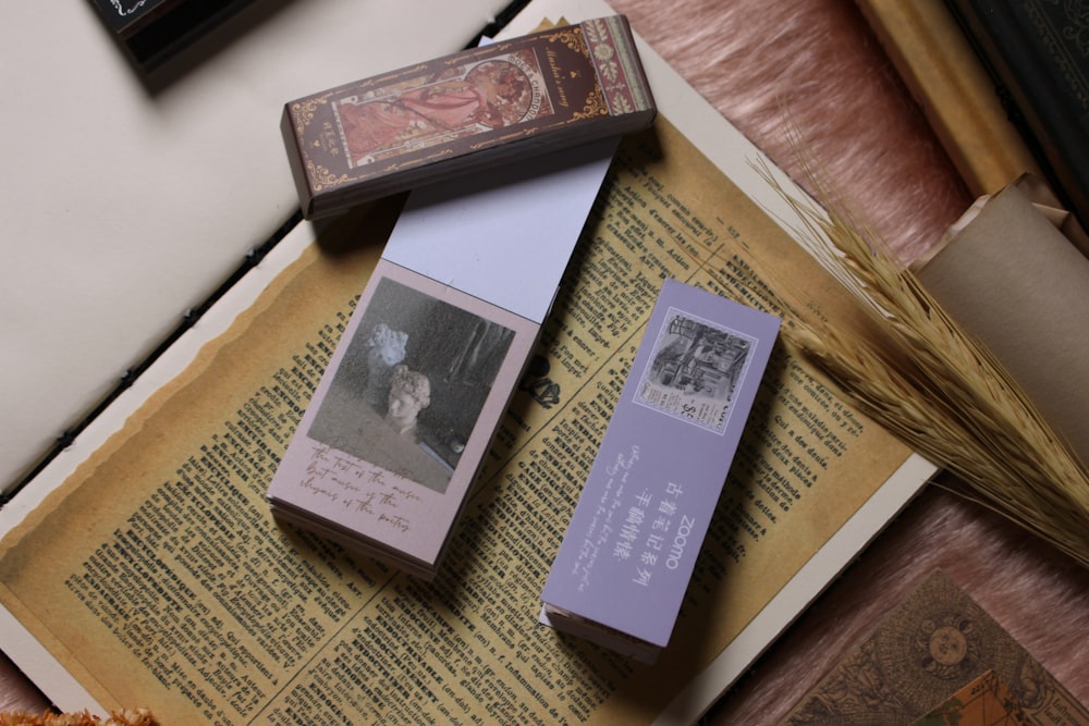 A couple of boxes sitting on top of an open book photo – Free Flatlay Image  on Unsplash