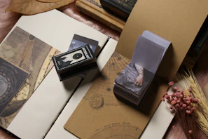 Styled shot of matching couple's zodiac jewellery displayed beside a handwritten note on textured paper