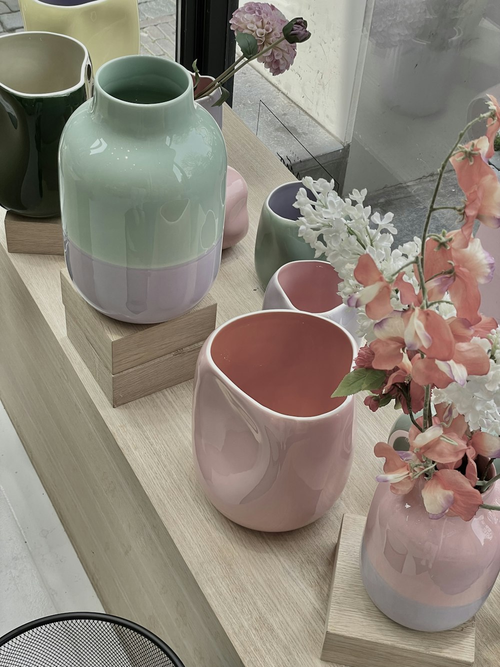 a row of vases sitting on top of a table