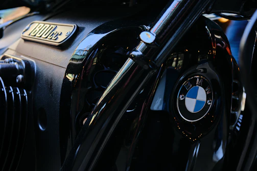 Close-up of the BMW R1000's engine and exhaust, gleaming under the afternoon sun.