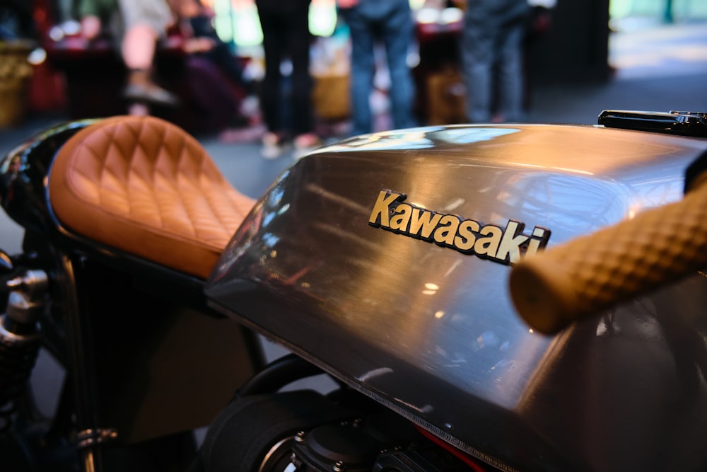 a close up of a motorcycle with people in the background