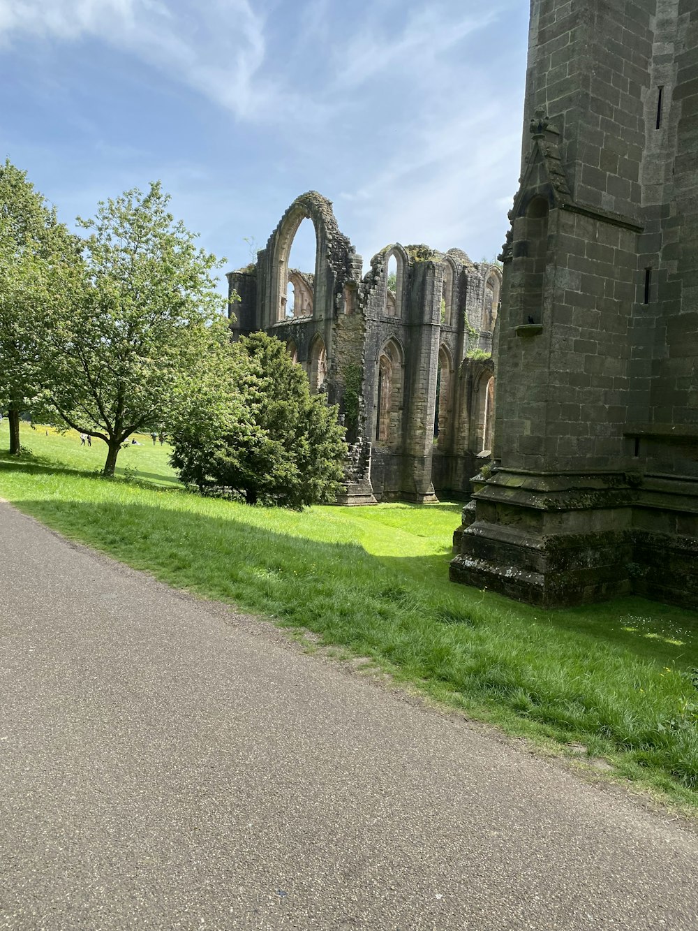 a stone building sitting on top of a lush green field