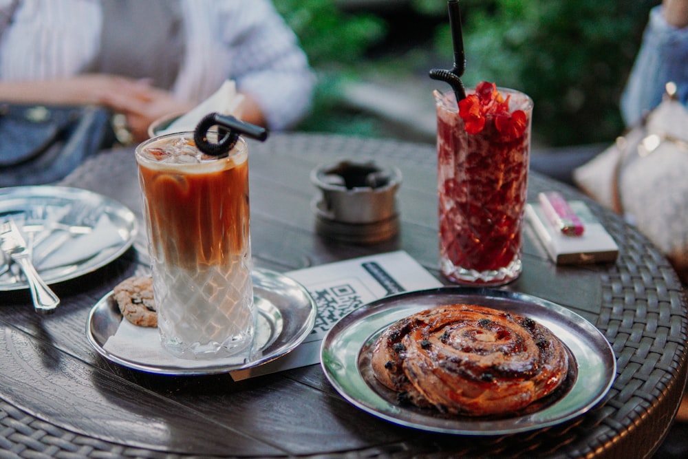 a table topped with a plate of food and a drink