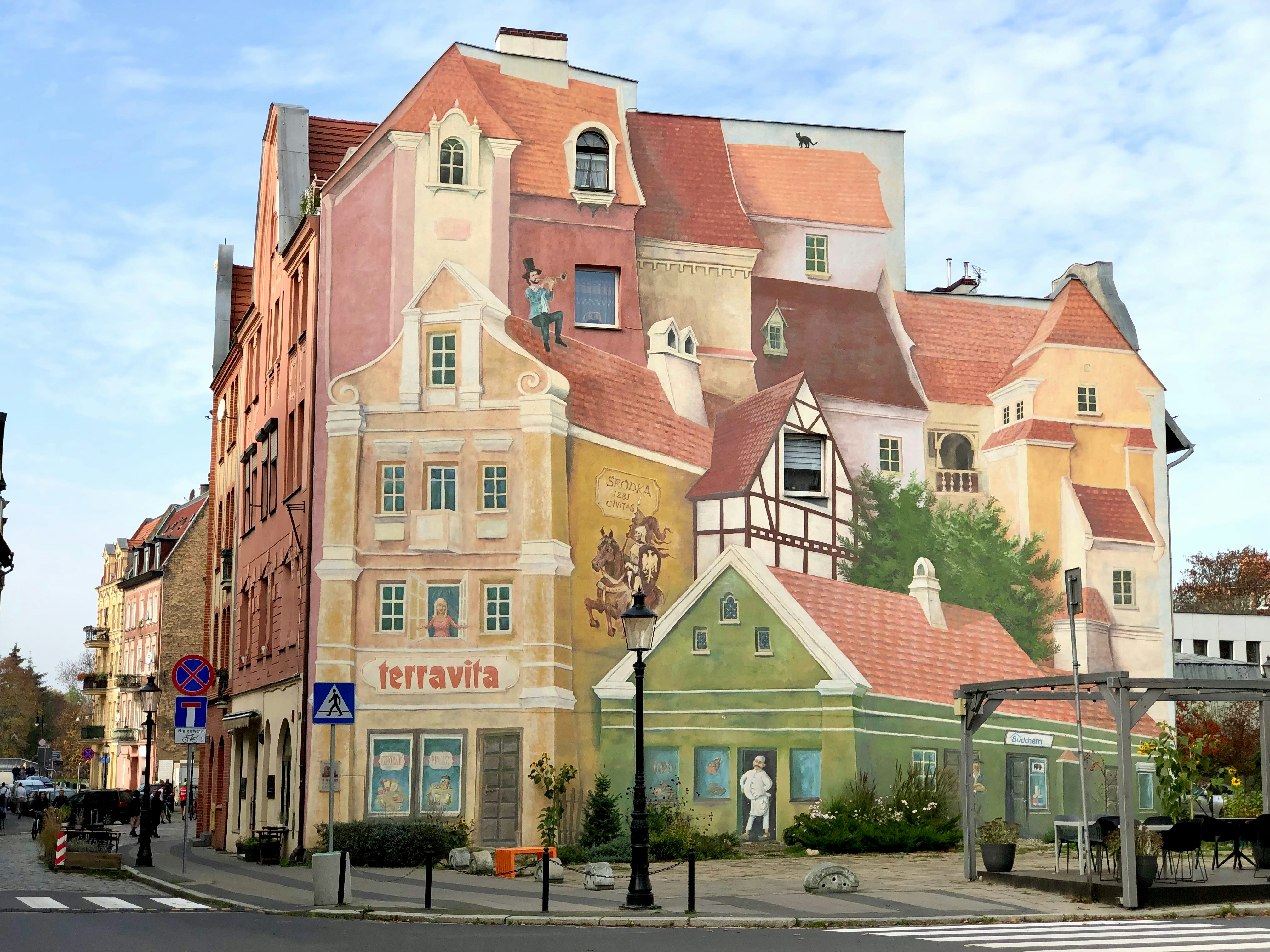 a large mural of a building on the side of a street