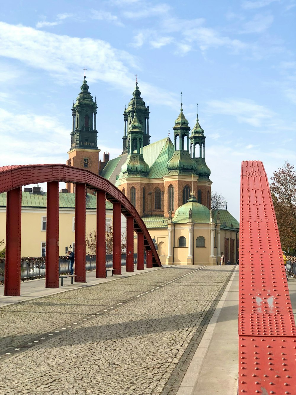 a large building with a red bridge in front of it