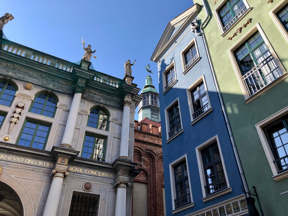 a row of buildings with statues on top of them