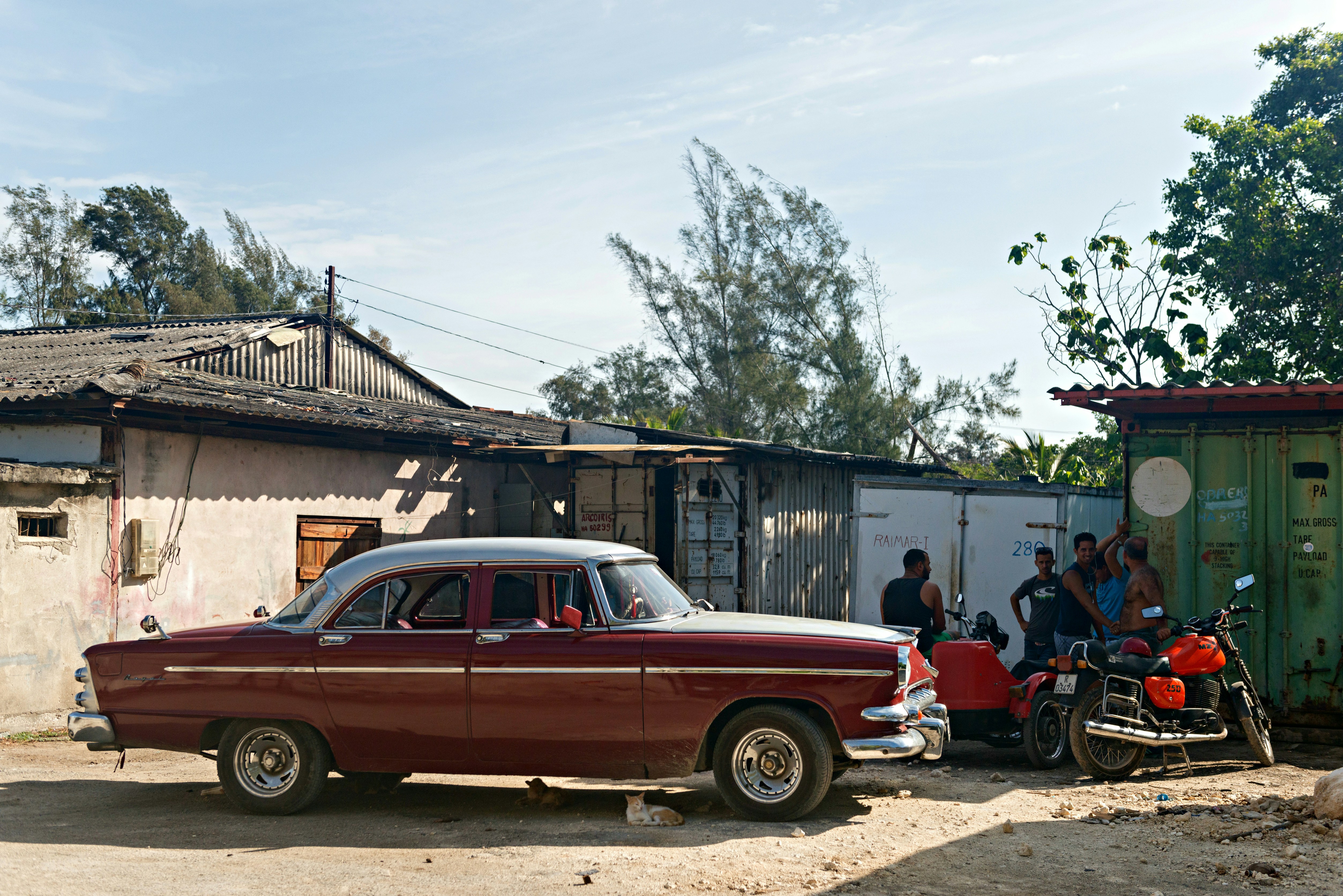 a red car parked in front of a building