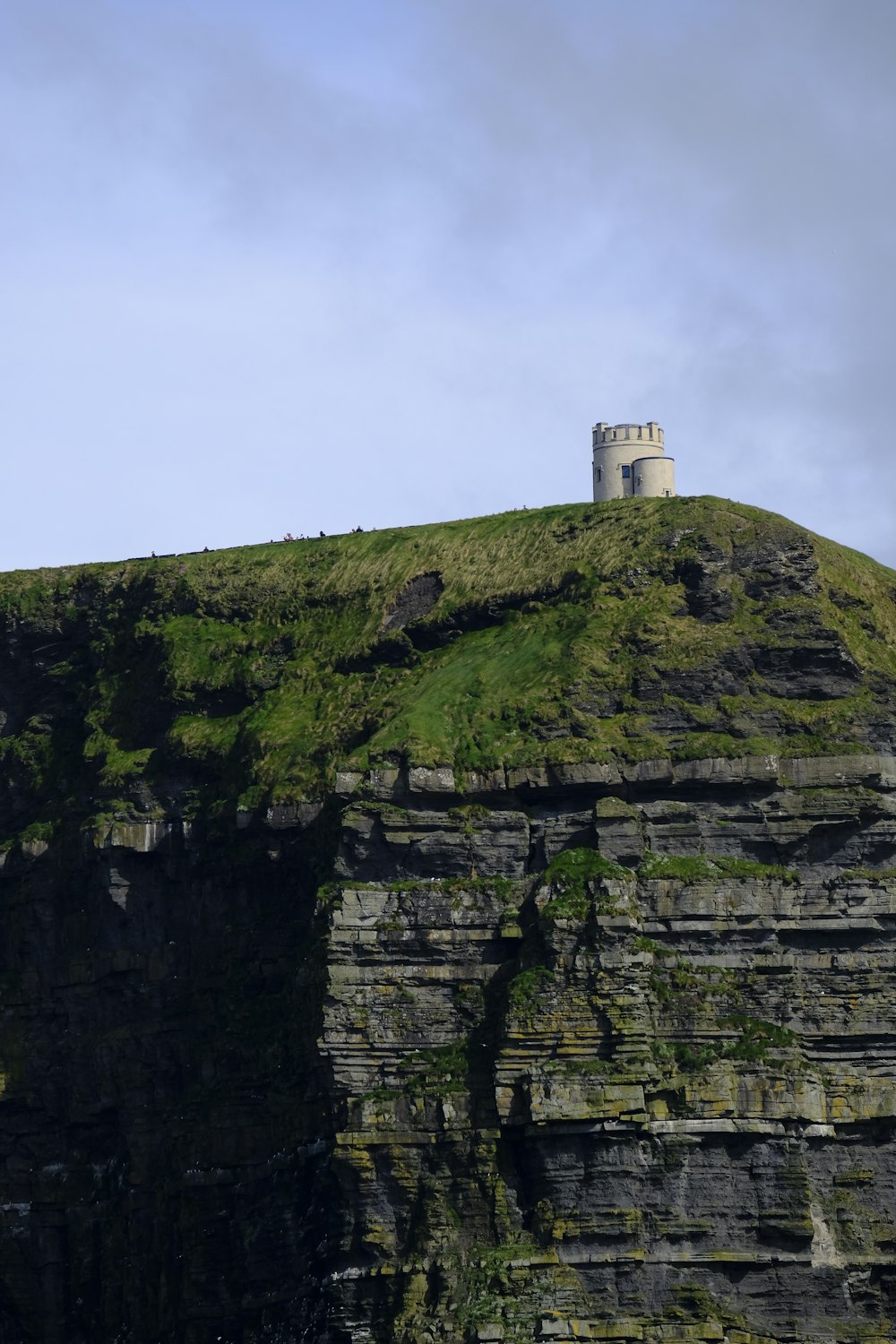 a tall cliff with a tower on top of it