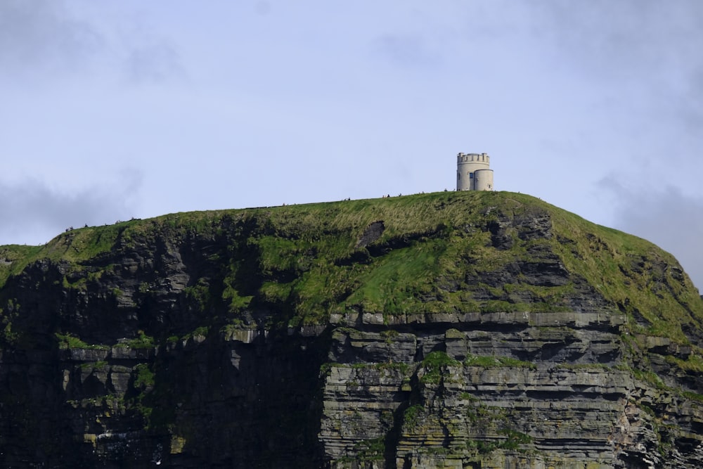 a tall cliff with a tower on top of it