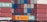 Multiple stacked shipping containers in various colors, including red, green, blue, and orange. The containers are branded with names such as Hapag-Lloyd and China Shipping, and they are stacked on a freight train.