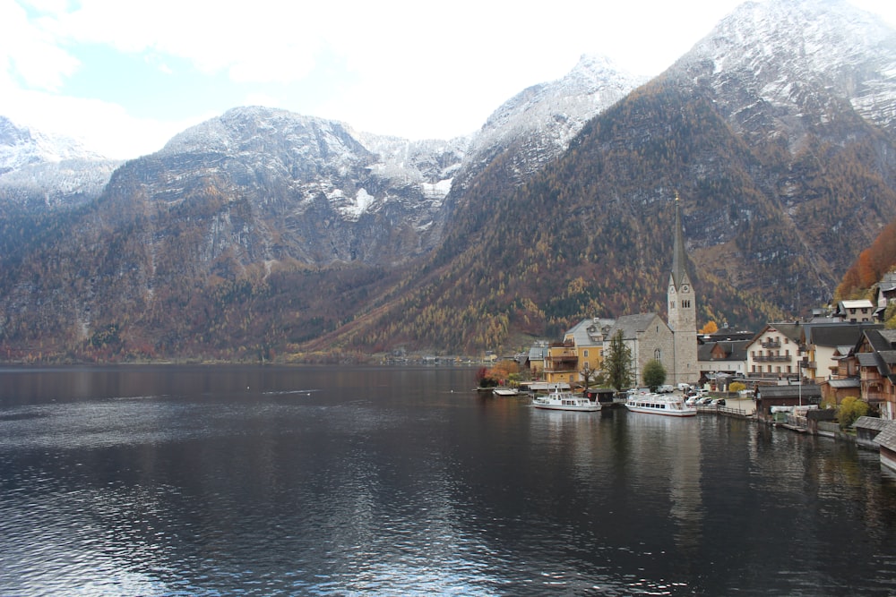 a small town on a lake surrounded by mountains