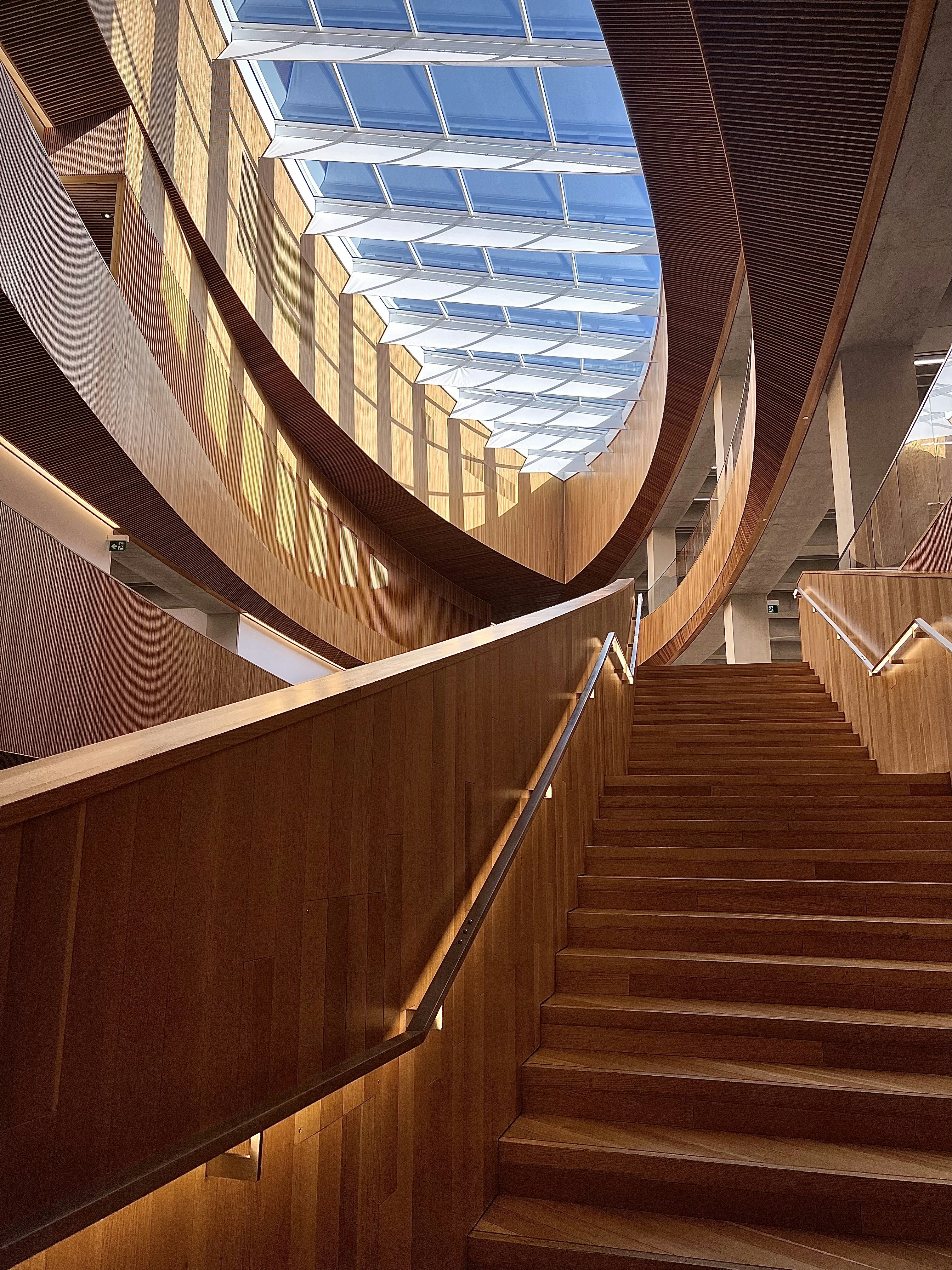 a wooden staircase with a skylight above it