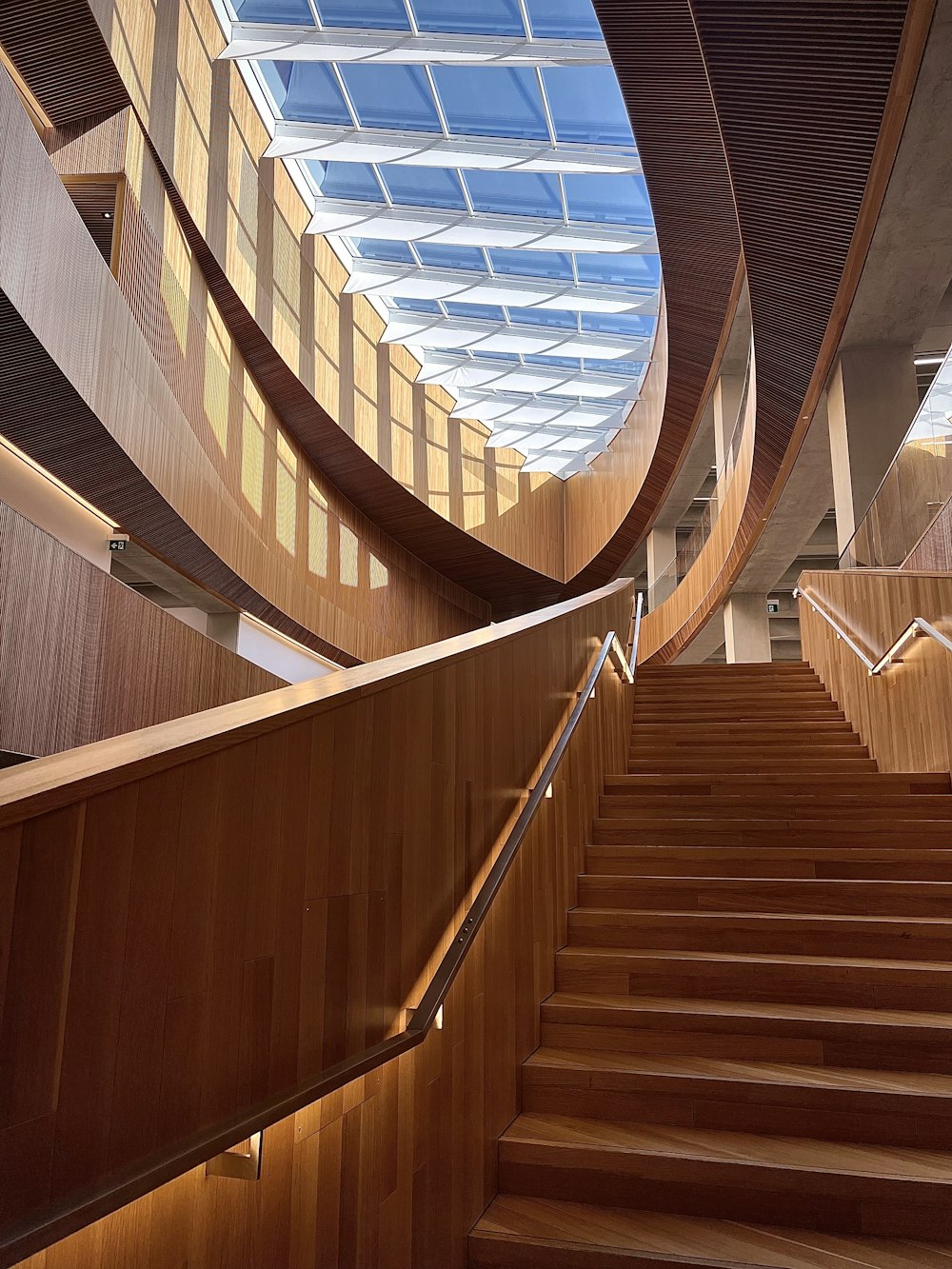 a wooden staircase with a skylight above it