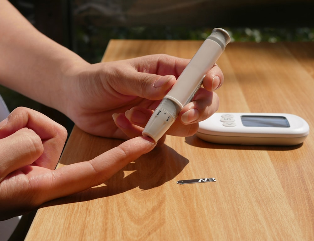 a person sitting at a table with a cell phone