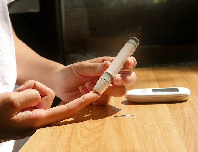 A smartwatch and smartphone displaying health tracking data on a kitchen table