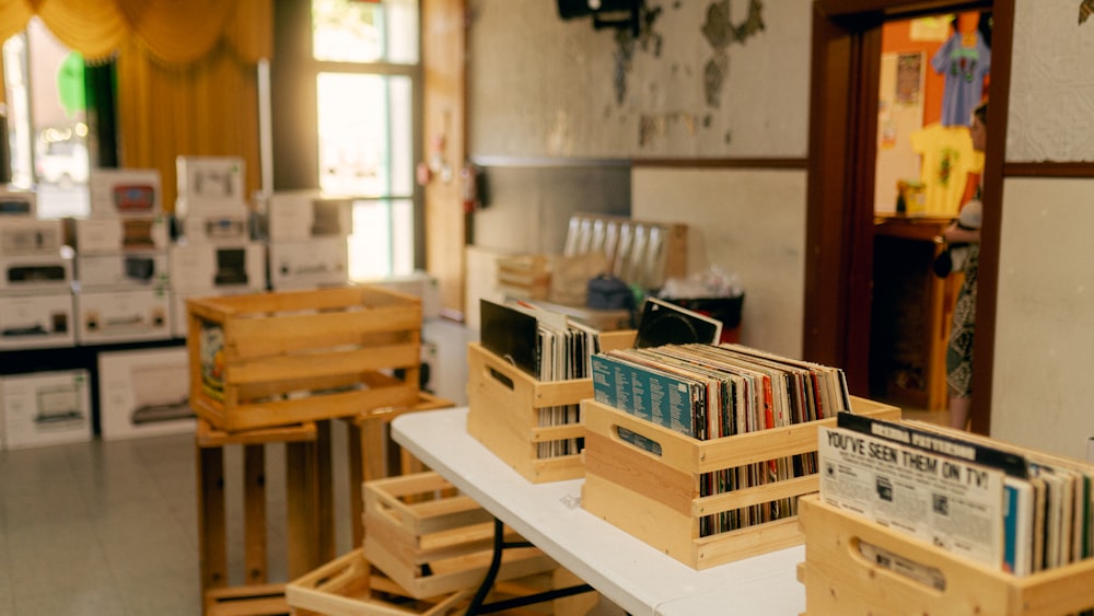 a room filled with lots of wooden crates filled with books