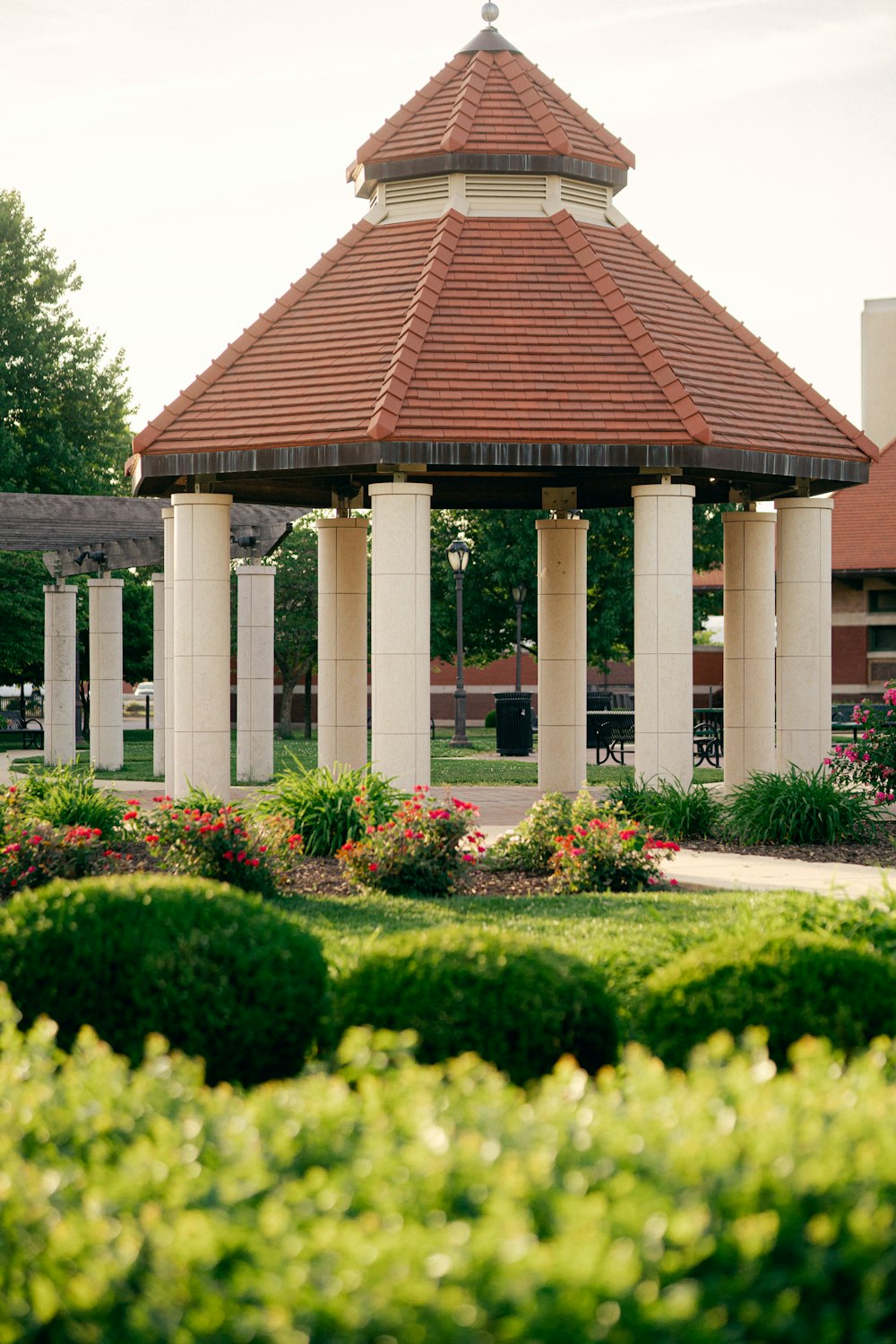 a gazebo in the middle of a flower garden