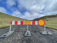a road closed off with a sign on it