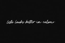 A black background with white handwriting stating 'life looks better in colour'.