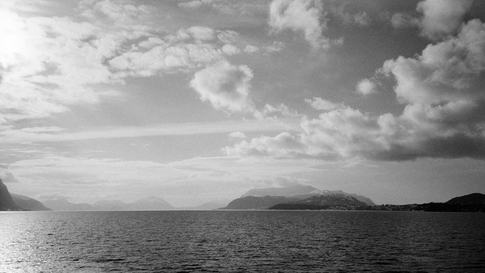 a large body of water with mountains in the background