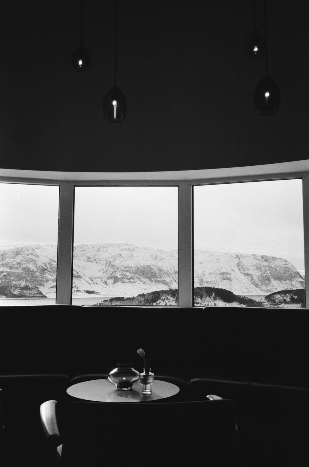 a black and white photo of a table and a window