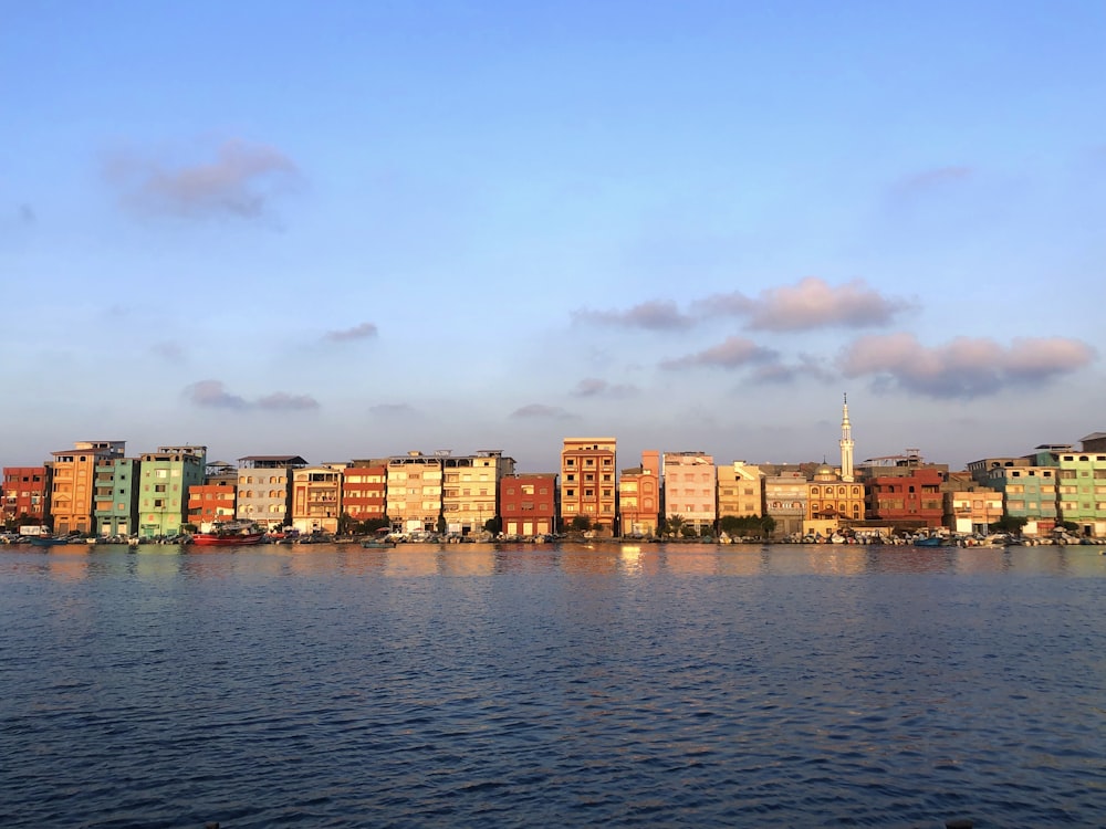 a large body of water with a city in the background