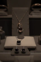 Loose Ceylon sapphires and zircons displayed in a handcrafted wooden tray with natural light highlighting their clarity.