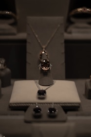 Sophisticated display of various fine diamond and gold jewelry pieces arranged on a dark wooden table.