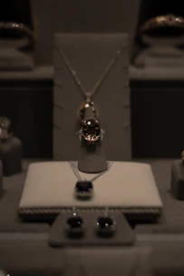 A display of beautifully crafted rings and necklaces sparkling under soft lighting.