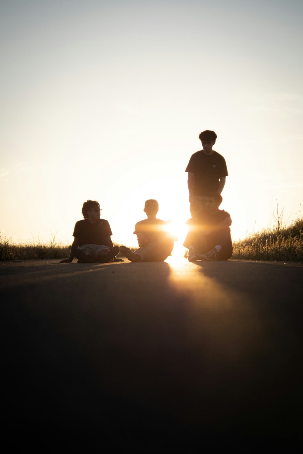 a group of people sitting on the side of a road