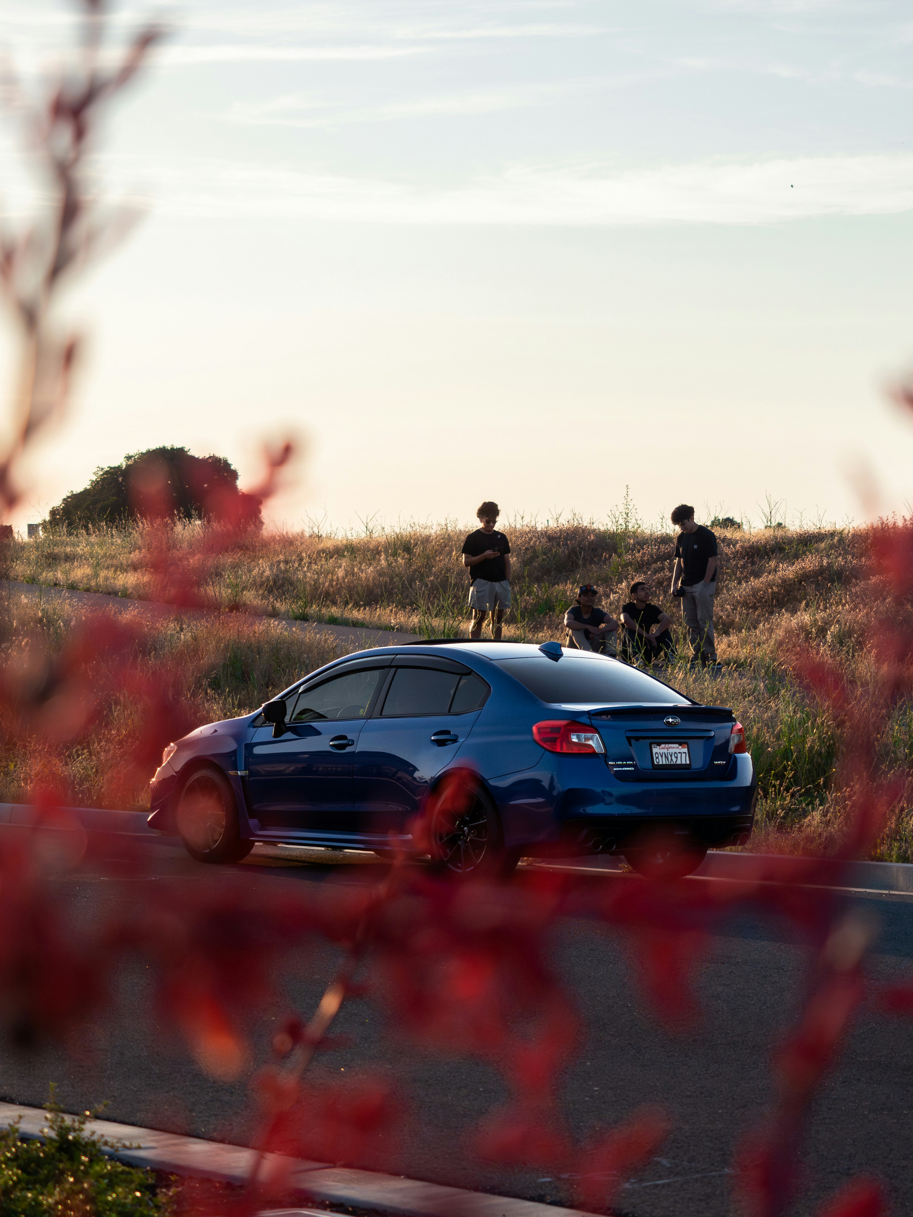 a blue car parked on the side of a road