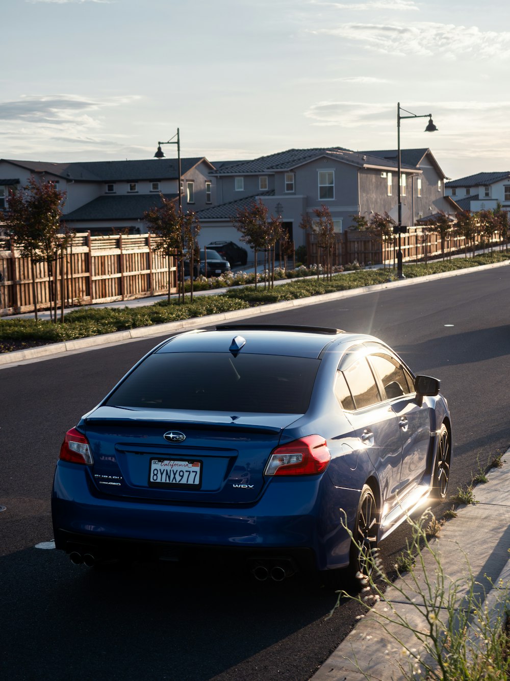 a blue car parked on the side of the road