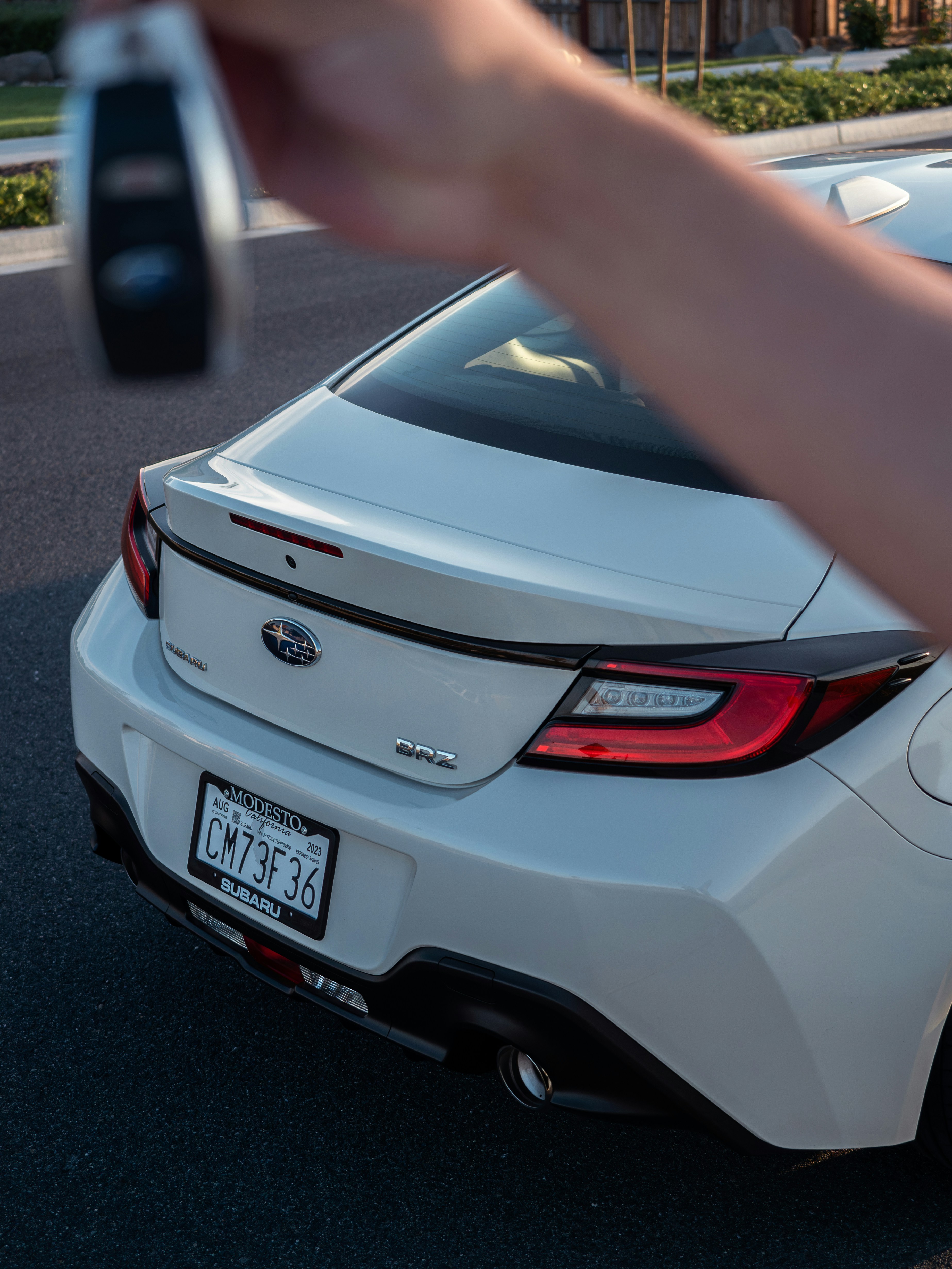 a person taking a picture of a white car