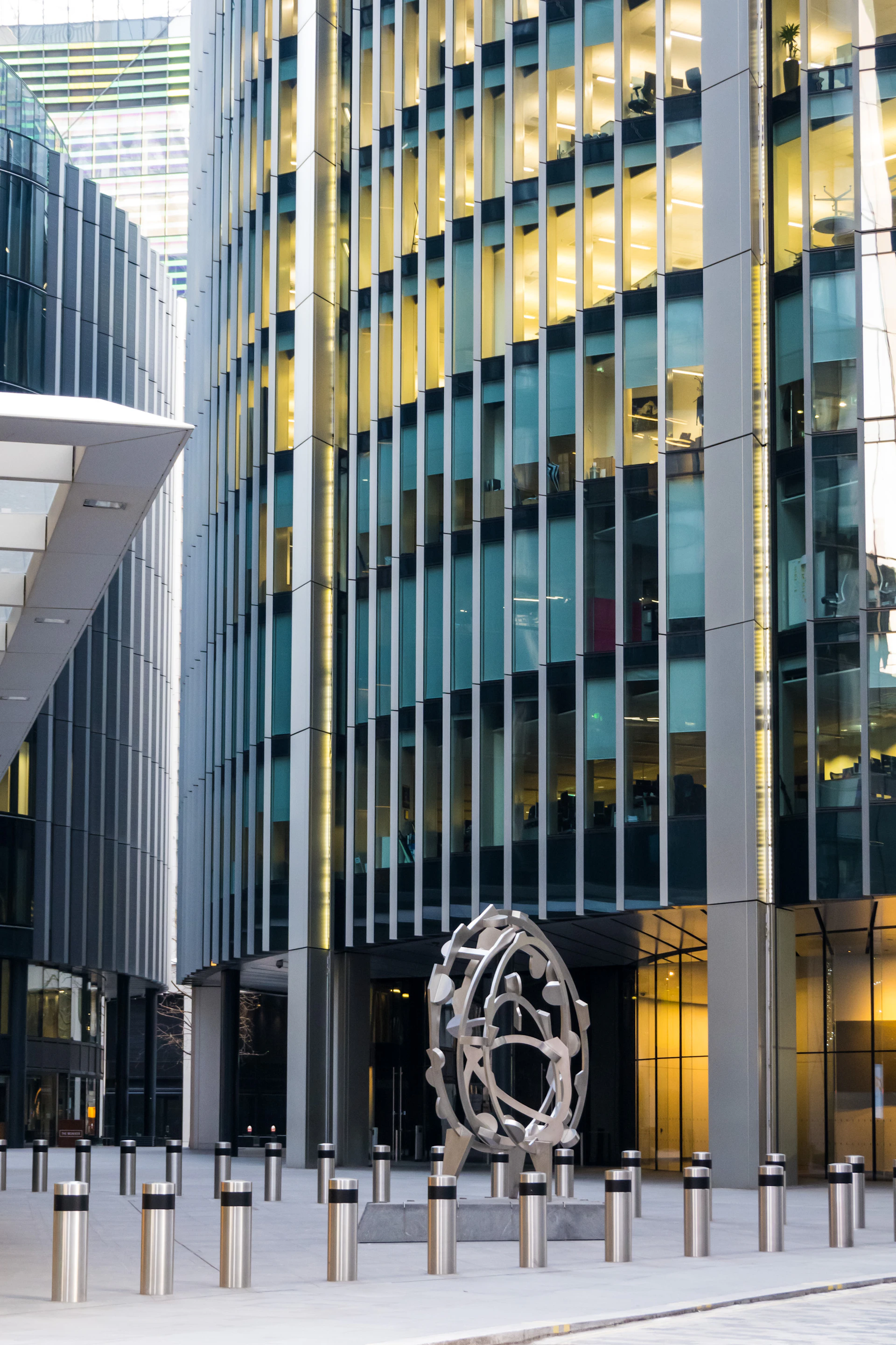 a tall building with a sculpture in front of it