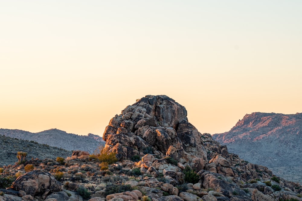 a large rock formation in the middle of a desert