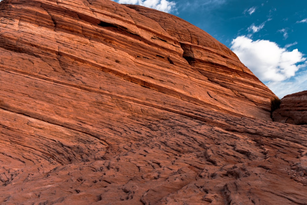 a large rock formation with a sky in the background